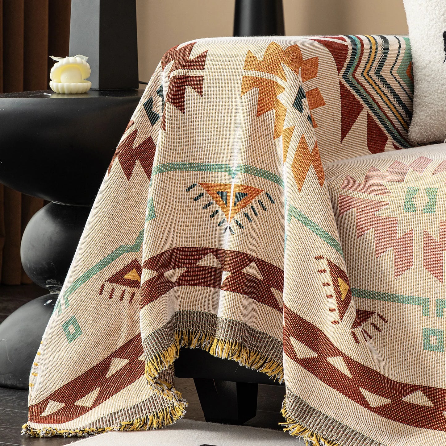 Bohemian design couch cover with natural tones draped over a sofa in a home living room setting. 